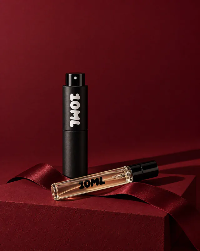 A 10ML atomiser and a filled sample vial on a claret plinth with a satin ribbon